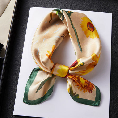 Carré de soie 100 pourcent véritable, foulard polyvalent aux couleurs vibrantes sur un livre.