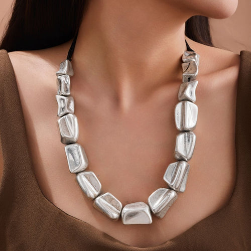 Collier géométrique carré tressé en argent antique, un bijou statement au design exagéré et aux lignes noires contrastantes.