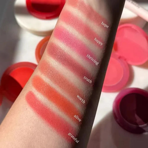 Luminizer & Blush Mat Longue Tenue - Waterproof in a set of four Rare Beauty products on a table.