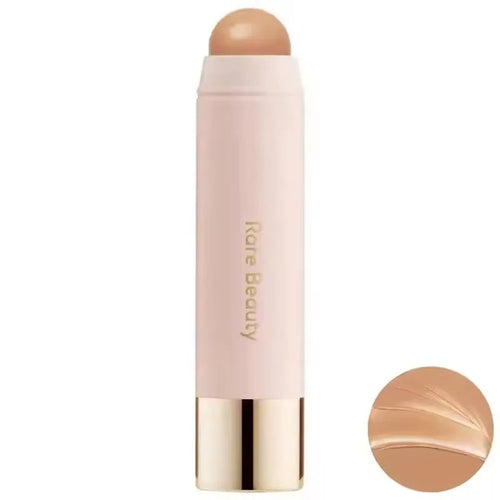 Stick Contouring nacré & Illuminateur – Contrôle Sébum by Rare Beauty in various shades displayed on a vanity.