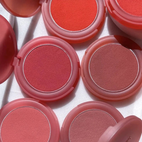 Luminizer & Blush Mat Longue Tenue - Waterproof in a set of four Rare Beauty products on a table.