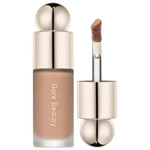 Luminizer & Blush Mat Longue Tenue - Waterproof in a set of four Rare Beauty products on a table.