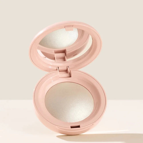 Stick Contouring nacré & Illuminateur – Contrôle Sébum by Rare Beauty in various shades displayed on a vanity.