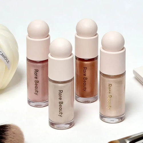 Luminizer & Blush Mat Longue Tenue - Waterproof in a set of four Rare Beauty products on a table.