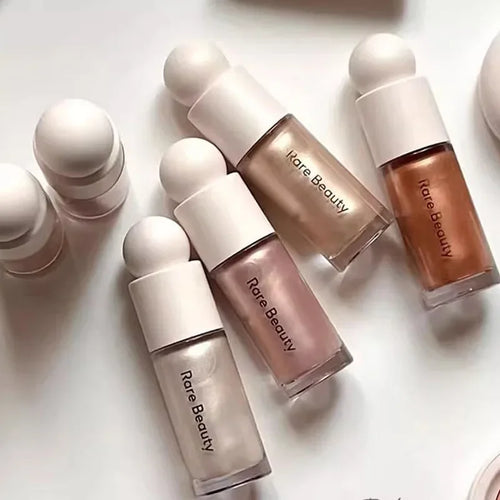 Luminizer & Blush Mat Longue Tenue - Waterproof in a set of four Rare Beauty products on a table.