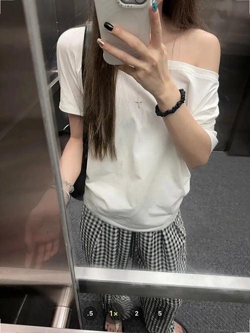 T-shirt femme Y2K Streetwear en gris, style décontracté avec manches courtes, porté sur l'épaule.