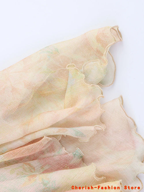 Jupe trapèze dentelle florale avec volants, design romantique, longueur mi-longue, en polyester fluide.