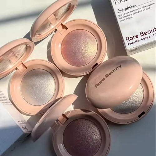 Stick Contouring nacré & Illuminateur – Contrôle Sébum by Rare Beauty in various shades displayed on a vanity.